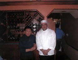 波士頓意大利區 Sage 小館主人兼主廚 Anthony Susi 在廚房門口酒架之前。